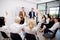 Young caucasian businessman asking opinion and brainstorm of employee while raise hand up for participation together.