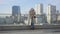 Young caucasian businesswoman standing with coffee cup in the city and looking away. Confident brunette woman in elegant