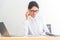 Young caucasian businesswoman working on laptop and thinking  in modern office. Smart businesswomen seriously working on her work