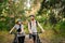 Young caucasian couple of cyclists walk and push their mountain bikes along the forest road in the park. Active sports weekend.