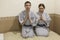 Young Caucasian couple sitting in traditional robes in japanese hotel