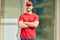 Young caucasian deliveryman smiling happy standing at the city