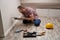 Young caucasian electrician putting power socket into wall