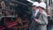 Young caucasian engineer man and woman in suit checking train with tablet in station.