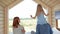 Young Caucasian family couple with baby daughter in a small modern rustic house with a large window. Lying on the bed