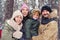 Young Caucasian family smiling waving to camera and having fun o