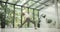 young caucasian fitness woman practicing yoga on a yoga mat in a modern studio with plants and large forest or garden