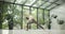 young caucasian fitness woman practicing yoga on a yoga mat in a modern studio with plants and large forest or garden