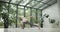 young caucasian fitness woman practicing yoga on a yoga mat in a modern studio with plants and large forest or garden