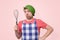 Young caucasian funny cook with a colander on his head
