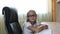 Young caucasian girl in glasses sitting on chair by table. Indoors close up view on pretty girl in glasses. White