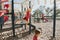Young Caucasian girl hanging on monkey bars in park on a playground. Summer outdoor activity for kids. Active preschool child