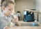 Young caucasian girl is holding a glass with water. Concept of good quality clean water. Kitchen faucet. Pouring fresh drink.