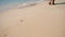 Young Caucasian Girl Leaving Footprints in the White Sand of a Tropical Beach In Thailand. HD Slowmotion.