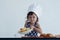 A young Caucasian girl with a plate of bread various pastries that she just finished from the oven