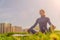 A young Caucasian girl practices yoga meditation in the fresh air. The concept of peace of mind