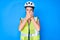 Young caucasian girl wearing bike helmet and reflective vest shocked covering mouth with hands for mistake