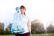 Young Caucasian girl wearing t shirt and baseball cap posing outdoor with garbage bag, cares for the environment, standing with