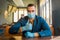 Young caucasian guy businessman in a blue suit and protective gloves and a medical mask shows a cool thumb up