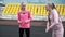 Young caucasian identical twins in sportswear stretching their bodies at stadium