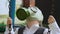 Young Caucasian kid in business suit breathe in green protective rubber gas mask on his face close up. Man raise his head up