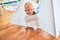 Young caucasian kid playing at kindergarten with toys. Preschooler boy happy at playroom