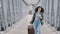 Young caucasian lady girl woman female passenger tourist traveler with suitcase pushing carries luggage running rush