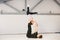 A young Caucasian male and female couple practicing acrobatic yoga in a white gym on mats. They are in the STAR pose