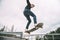 Young caucasian male skateboarder in the air jumping off a rail. Copy space.