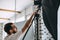 Young caucasian man adjusts lighting equipment in a photo studio