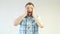 A young caucasian man with a beard experiences emotions of fear and surprise, close-up, white background, shock