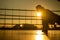 Young caucasian man doing push-ups in the boxing ring outdoors at sunset.