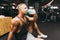 Young caucasian man drinking water after exercise.man in the gym drinking from the shaker