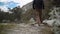 young caucasian man hiking through a mountainous landscape