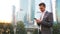 Young caucasian man holding smartphone for business work.