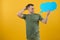 Young caucasian man isolated on yellow background holding a thinking speech bubble and doing OK sign