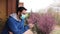 Young caucasian man with mask looking out onto home terrace during quarantine due to coronavirus covid19 pandemic