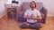 Young caucasian man meditating in his appartment. Mindfulness concept