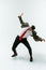 Young caucasian man moving flexible on white studio background