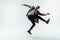 Young caucasian man moving flexible on white studio background