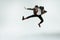 Young caucasian man moving flexible on white studio background