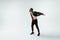 Young caucasian man moving flexible on white studio background