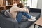 Young caucasian man patient stressed sitting on sofa at psychology clinic