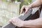 A young caucasian man is repairing a window opening, removing the silicone insulation.