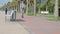 Young Caucasian man riding electric scooter along the sea coast near the beach at sunny summer day. Male driving e