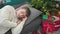 Young caucasian man sleeping on sofa by christmas tree at home