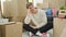 Young caucasian man smiling proud sitting on floor at new home