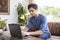 Young Caucasian man using laptop in a coffee shop