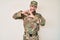 Young caucasian man wearing camouflage army uniform smiling in love doing heart symbol shape with hands