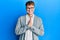 Young caucasian man wearing elegant clothes and glasses praying with hands together asking for forgiveness smiling confident